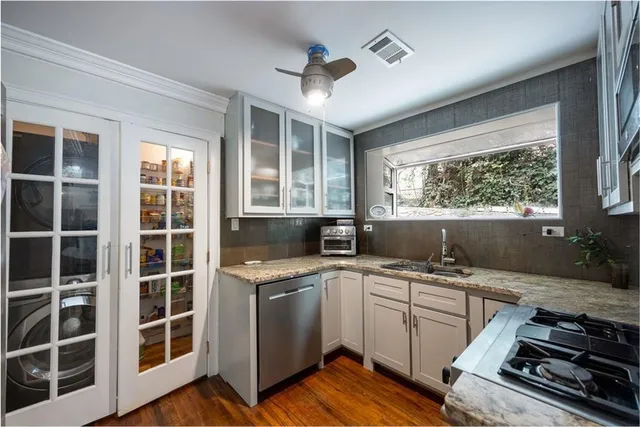 a kitchen that has a sink and a stove in it