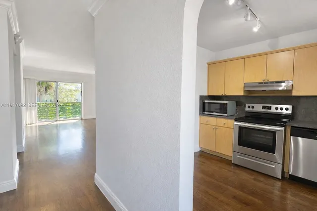 a kitchen with stainless steel appliances a stove a sink and a microwave