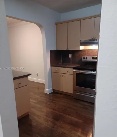 a kitchen with a refrigerator sink and cabinets