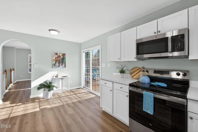 a kitchen with cabinets a sink and white appliances