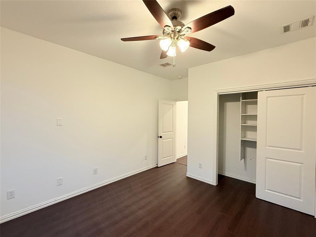 9815 Romo Street Irving, TX 75063 - Photo 15 of 25 an empty room with wooden floor fan and windows