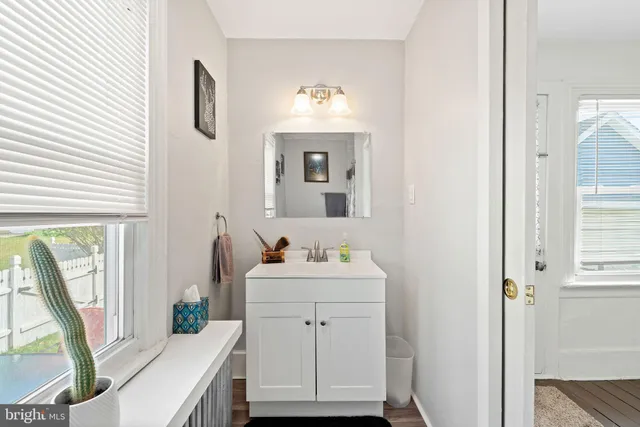 a bathroom with a sink toilet and mirror