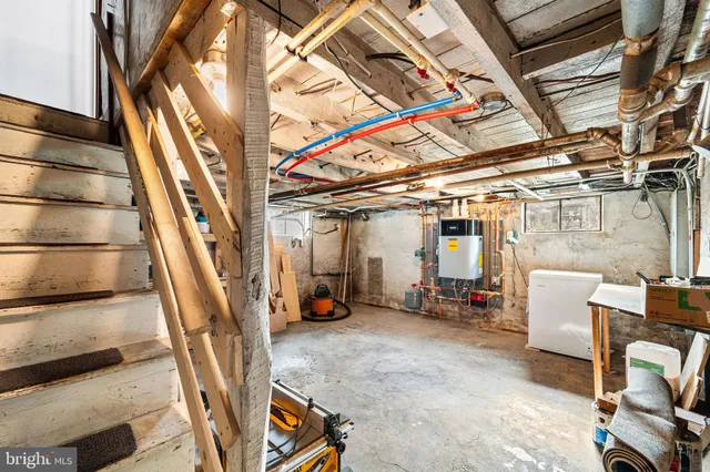 a view of an empty room with wooden floor and furniture