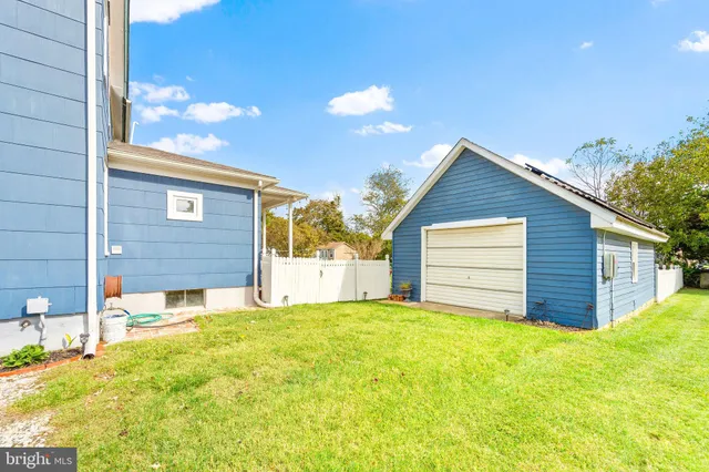 a view of a house with a yard and garage
