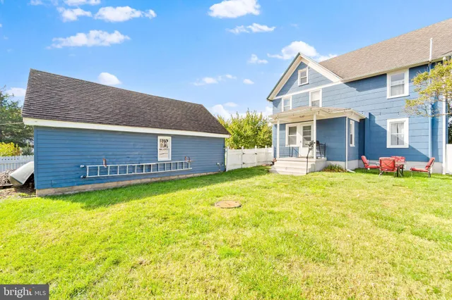 a view of a house with a yard porch and furniture