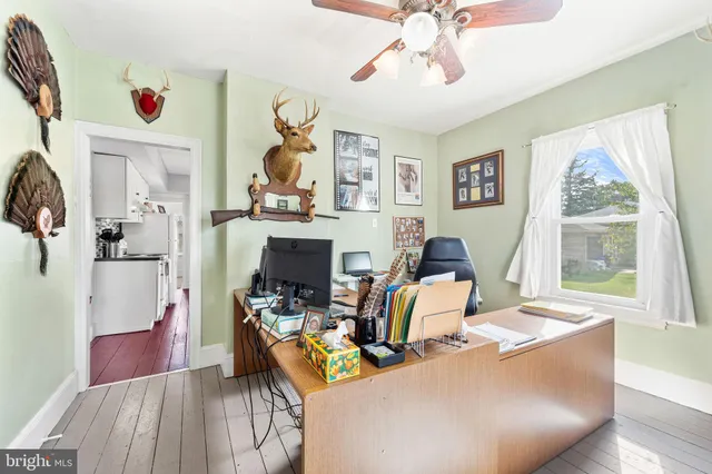 a workspace with wooden floor and a large window
