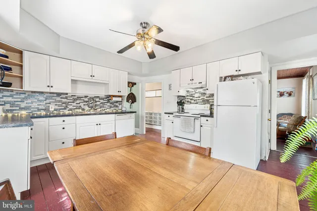 a kitchen with stainless steel appliances a refrigerator sink and cabinets