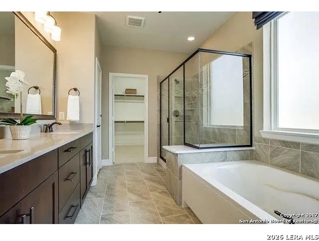 119 Aberdeen Boerne, TX 78015 - Photo 10 of 10 a bathroom with a granite countertop sink mirror bathtub and shower