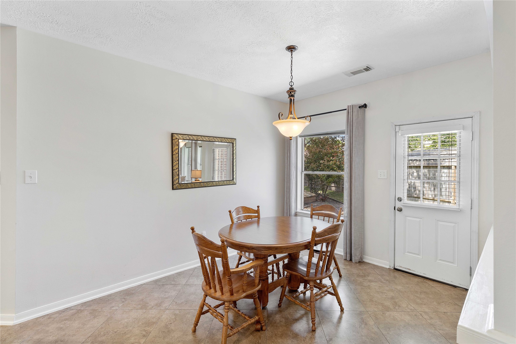 1707 Moston Drive Spring, TX 77386 - Photo 18 of 41 a view of a dining room with furniture window and wooden floor