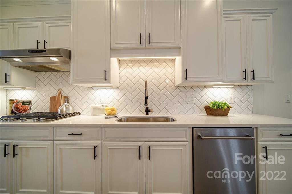 6309 Wakehurst Road Charlotte, NC 28226 - Photo 11 of 48 a kitchen with stainless steel appliances a sink and cabinets