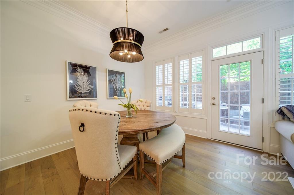 6309 Wakehurst Road Charlotte, NC 28226 - Photo 13 of 48 a view of a dining room with furniture wooden floor and chandelier