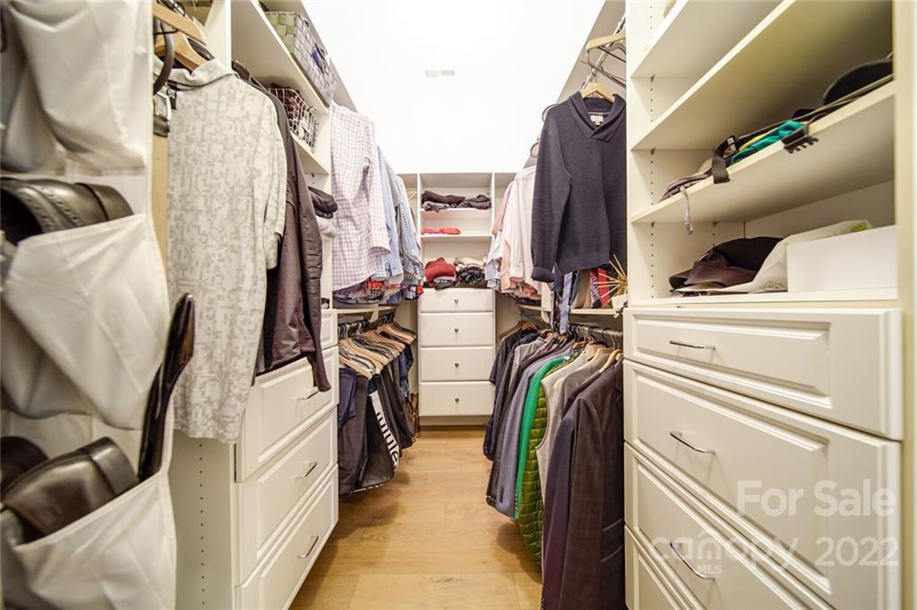 6309 Wakehurst Road Charlotte, NC 28226 - Photo 21 of 48 a view of walk in closet with clothes and shoes
