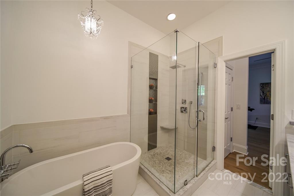6309 Wakehurst Road Charlotte, NC 28226 - Photo 23 of 48 a bathroom with a bathtub and a shower