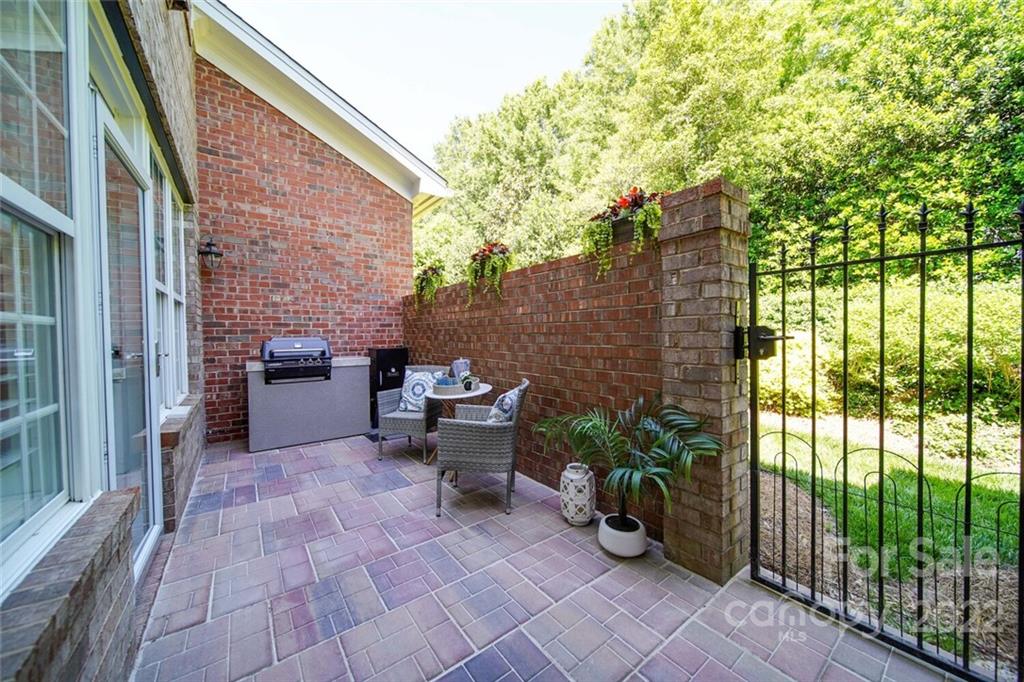 6309 Wakehurst Road Charlotte, NC 28226 - Photo 25 of 48 a view of a patio with table and chairs and potted plants