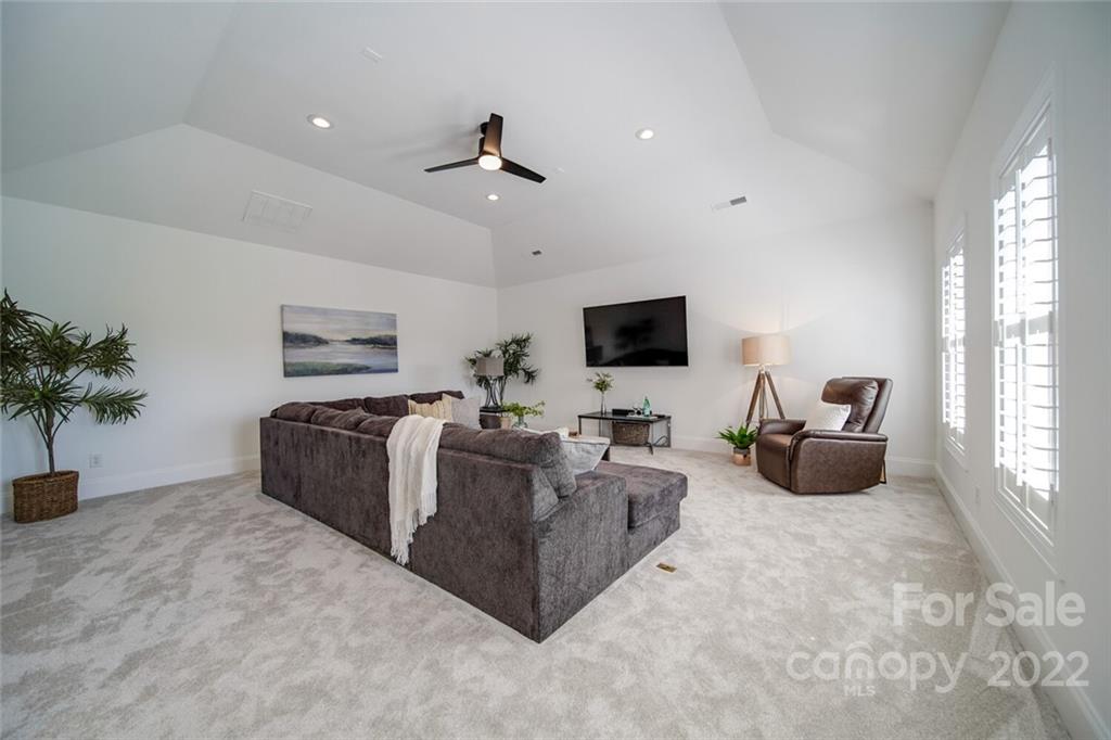 6309 Wakehurst Road Charlotte, NC 28226 - Photo 27 of 48 a living room with furniture and a flat screen tv