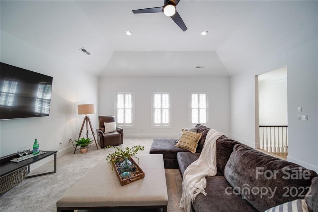 6309 Wakehurst Road Charlotte, NC 28226 - Photo 29 of 48 a living room with furniture and a flat screen tv