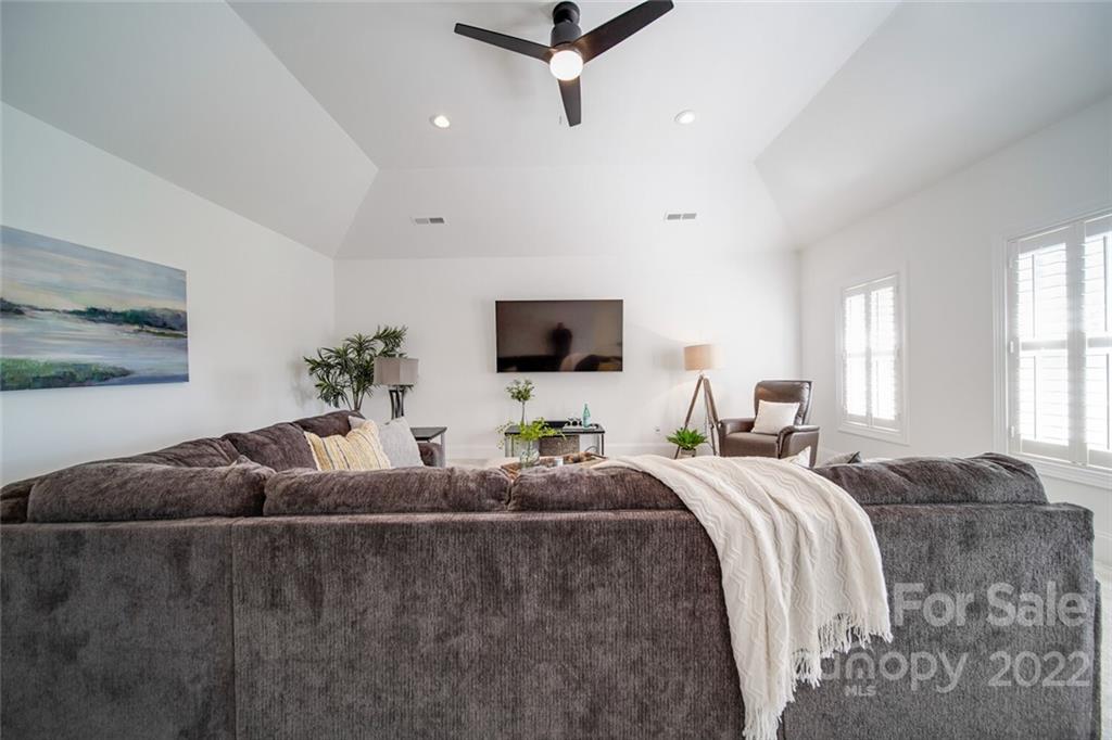 6309 Wakehurst Road Charlotte, NC 28226 - Photo 30 of 48 a living room with a couch and a flat screen tv