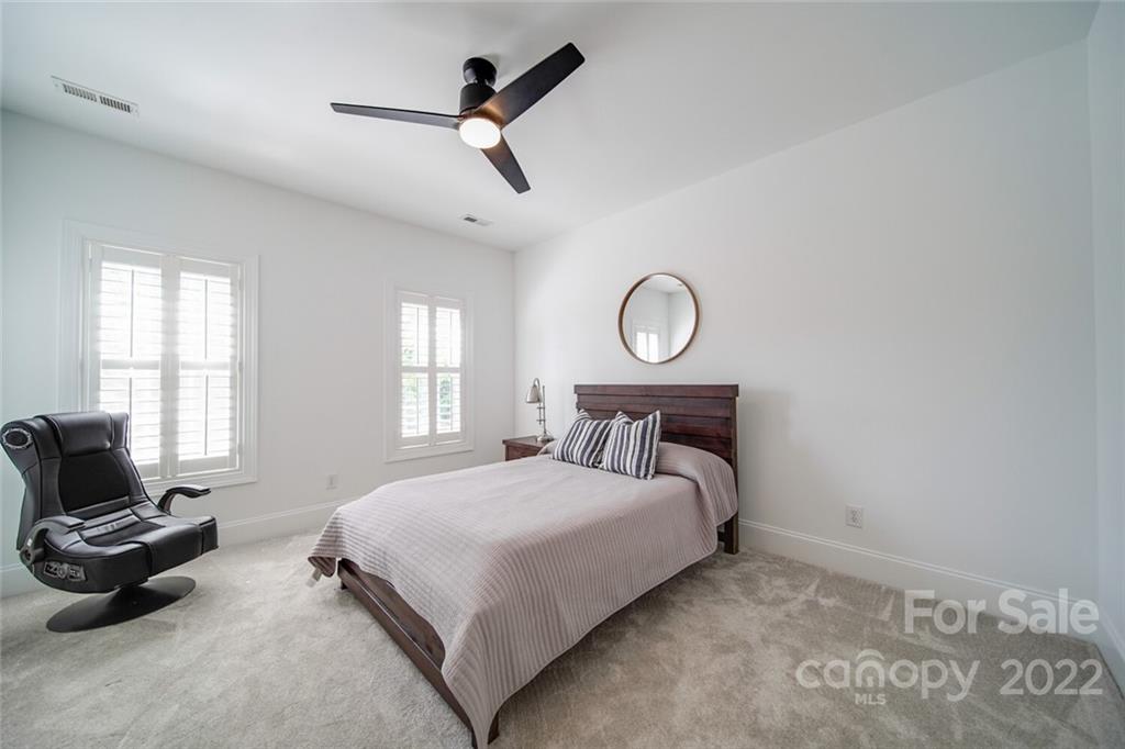 6309 Wakehurst Road Charlotte, NC 28226 - Photo 31 of 48 a bedroom with a bed a couch and a window