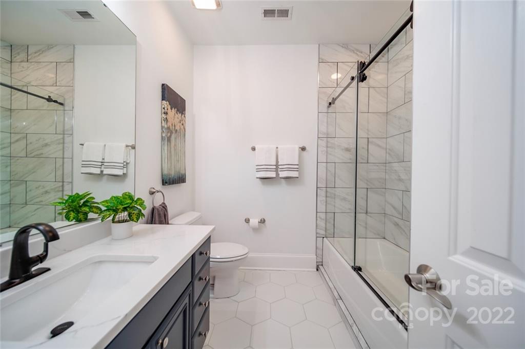 6309 Wakehurst Road Charlotte, NC 28226 - Photo 34 of 48 a bathroom with a granite countertop sink a toilet and shower