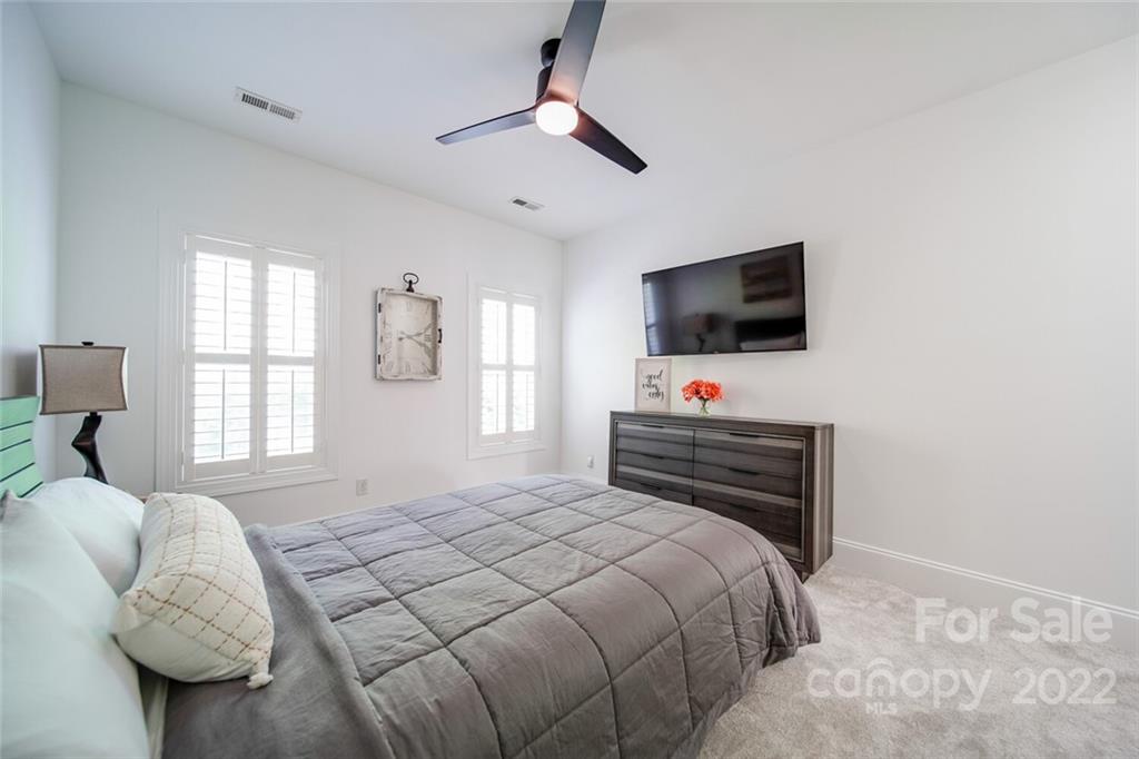 6309 Wakehurst Road Charlotte, NC 28226 - Photo 36 of 48 a bedroom with a bed window and flat screen tv