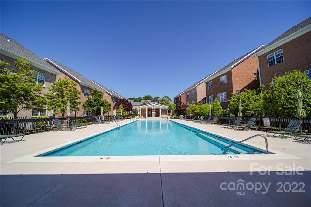 6309 Wakehurst Road Charlotte, NC 28226 - Photo 43 of 48 a view of a swimming pool with an outdoor seating