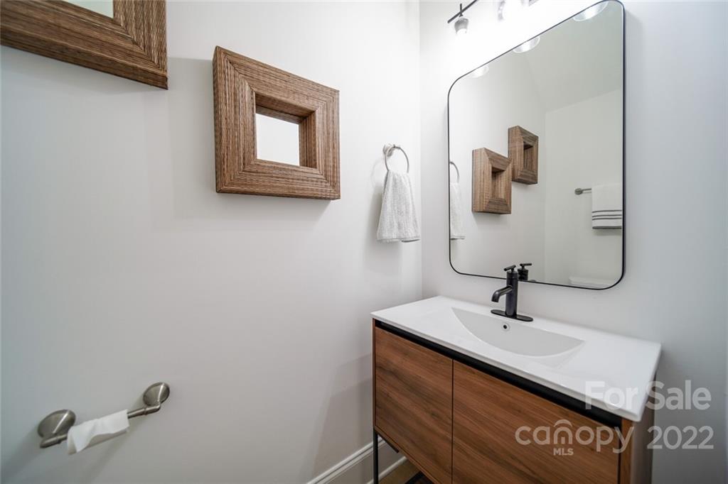 6309 Wakehurst Road Charlotte, NC 28226 - Photo 6 of 48 a bathroom with a sink and a mirror