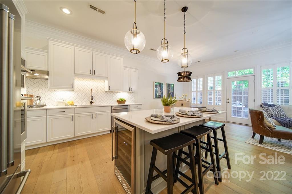 6309 Wakehurst Road Charlotte, NC 28226 - Photo 8 of 48 a kitchen with a table chairs stove and white cabinets