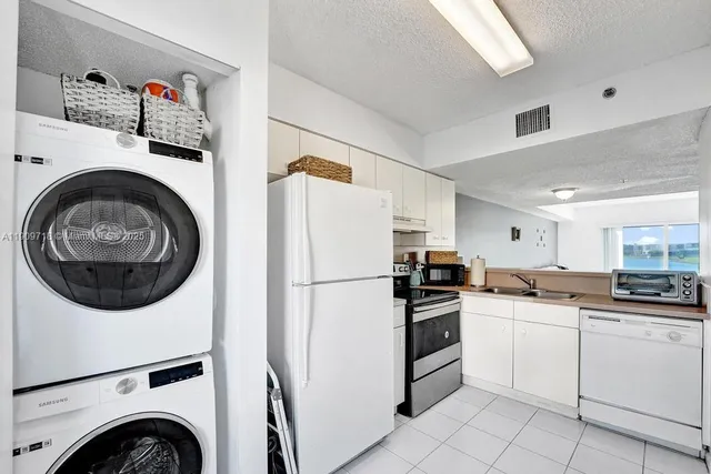 a kitchen with appliances a sink and cabinets
