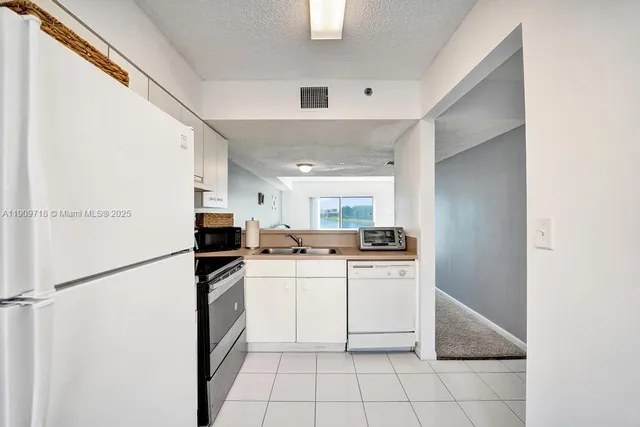 a view of kitchen with cabinets and wooden floor