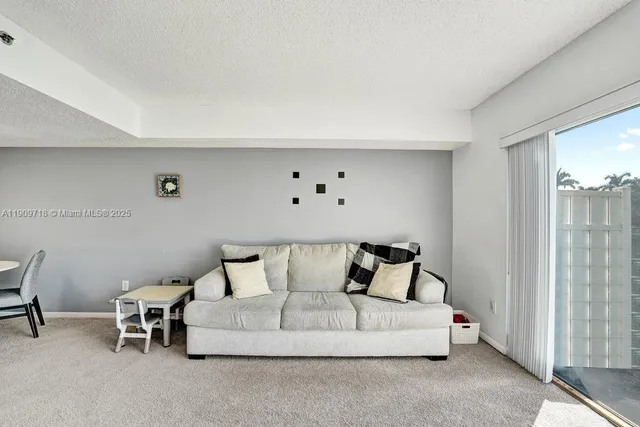 a living room with a large window and a flat screen tv