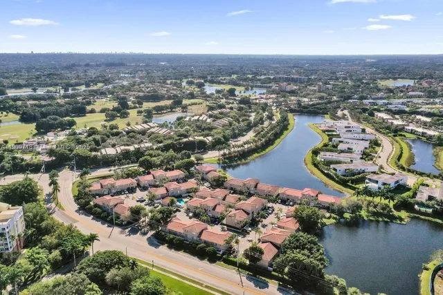 an aerial view of lake and residential houses with outdoor space