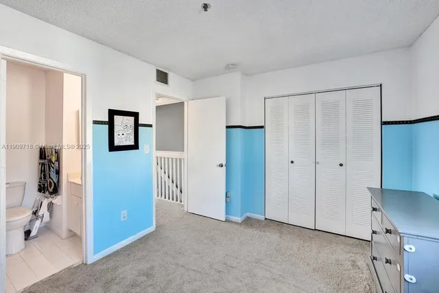 a spacious bedroom with a bed and a window