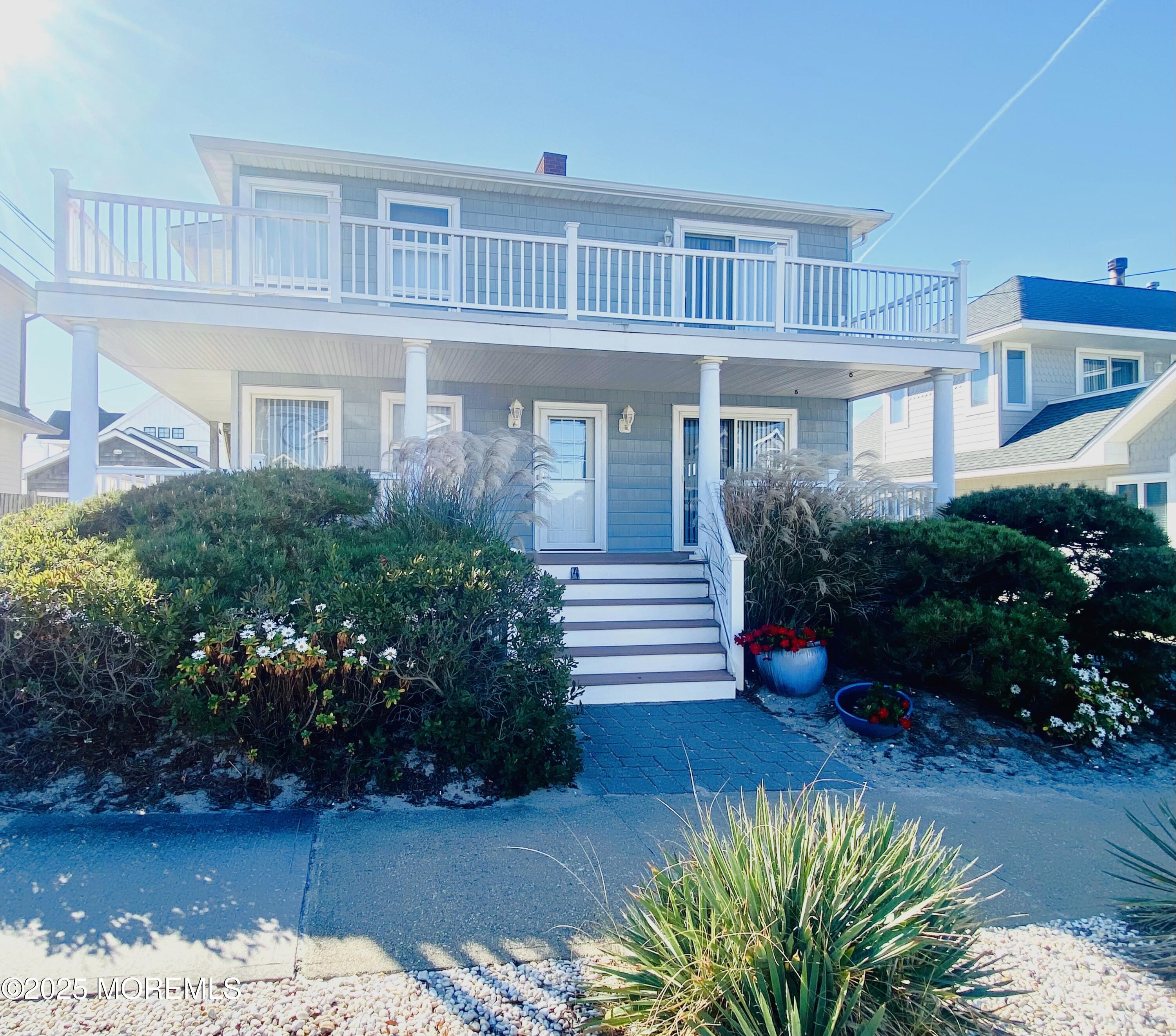 4 Camden Avenue, Unit DOWN Lavallette, NJ 08735 - Photo 1 of 14 a front view of a house with a yard and potted plants