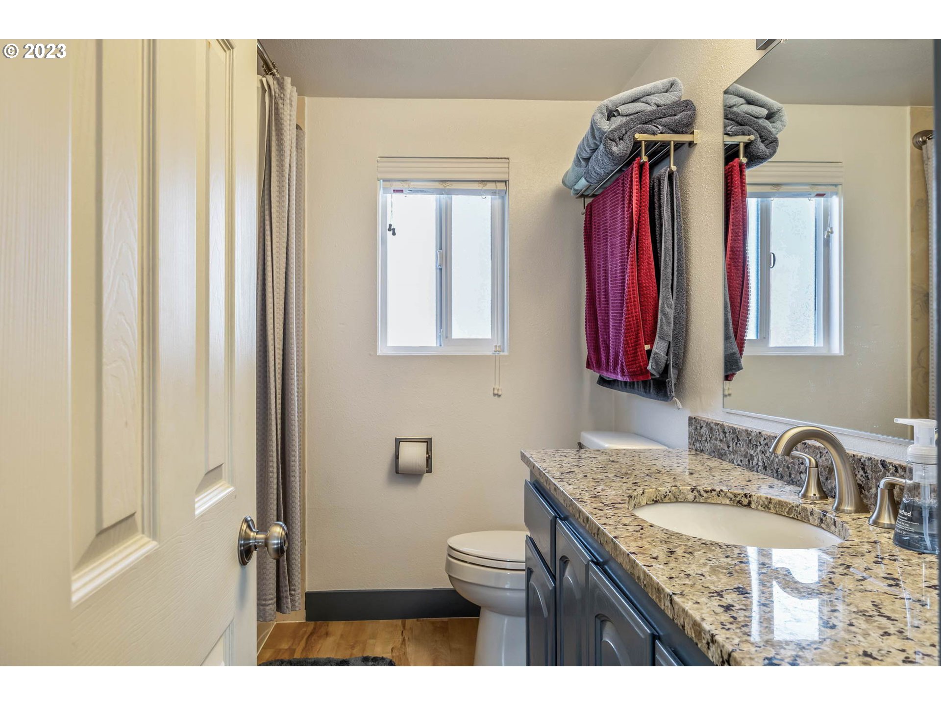 1083 Quinalt Street Springfield, OR 97477 - Photo 25 of 39 a bathroom with a granite countertop sink a mirror and a shower