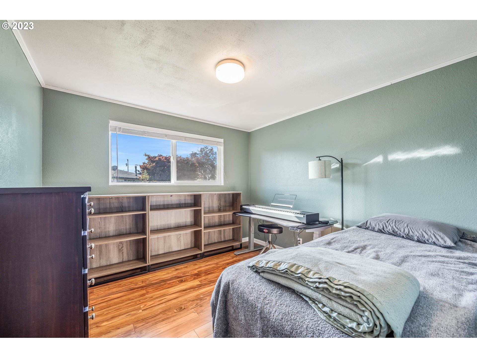 1083 Quinalt Street Springfield, OR 97477 - Photo 26 of 39 a bedroom with a bed and painting on the wall