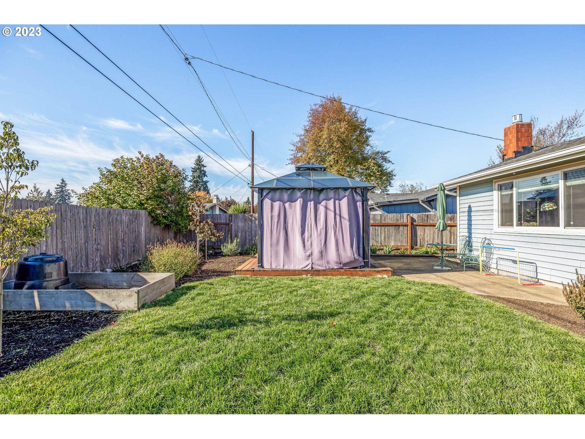 1083 Quinalt Street Springfield, OR 97477 - Photo 35 of 39 a view of a backyard with table and chairs and wooden fence