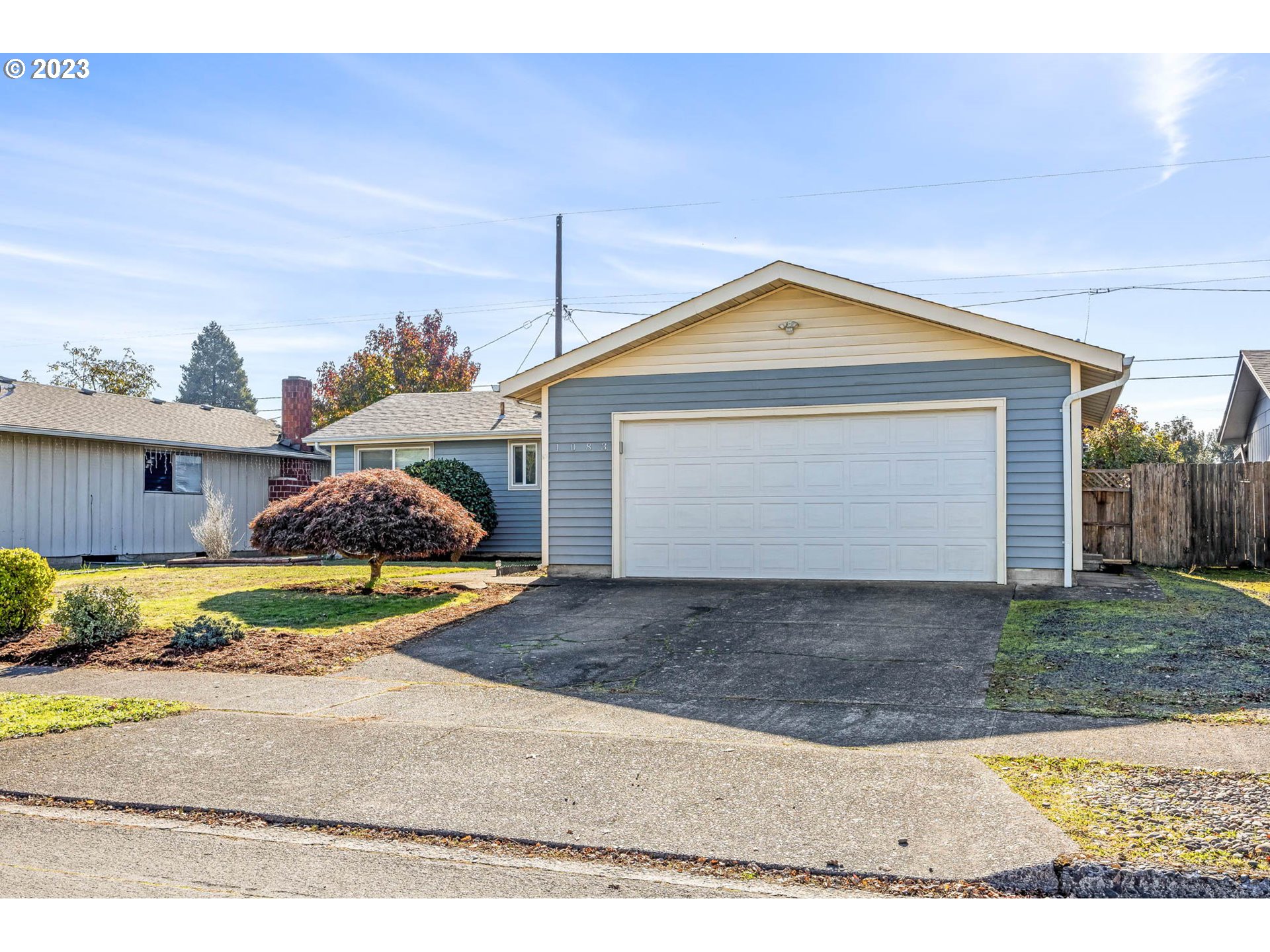 1083 Quinalt Street Springfield, OR 97477 - Photo 38 of 39 a front view of a house with a yard and garage