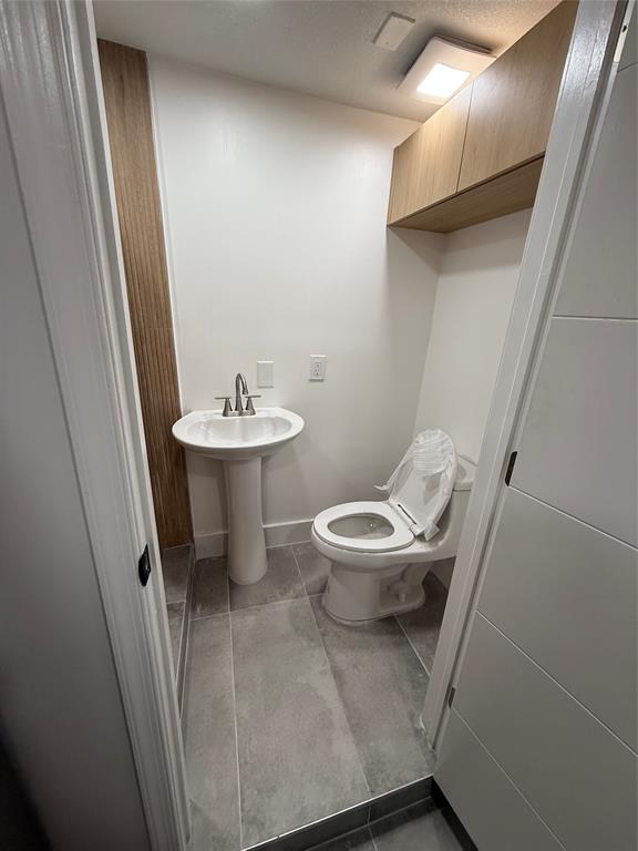 Undisclosed Address North Miami, FL 33168 - Photo 3 of 9 a bathroom with a toilet sink and mirror