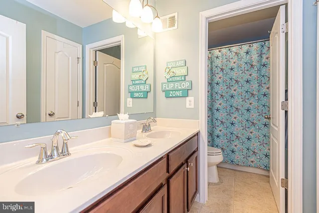 a picture of a bathroom with a shower curtain
