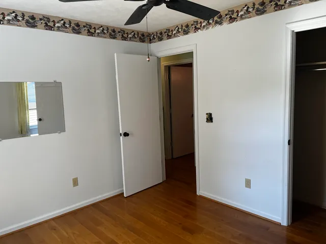 a view of a yard with wooden fence