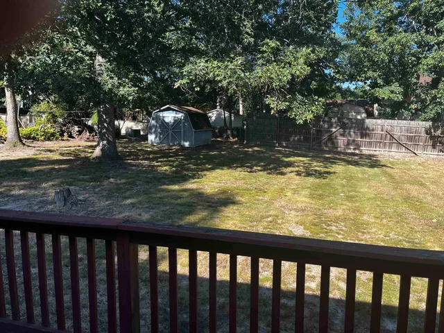 a kitchen with kitchen island granite countertop a sink and a stove