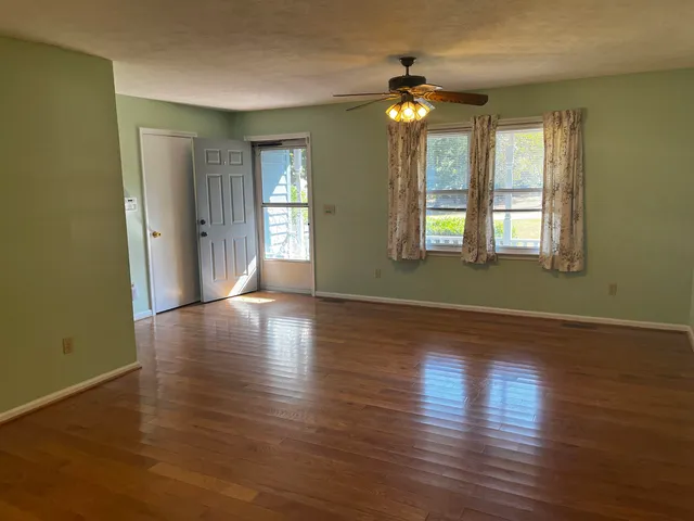 a kitchen with white cabinets and window