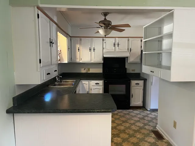 a bathroom with a glass door shower and a sink