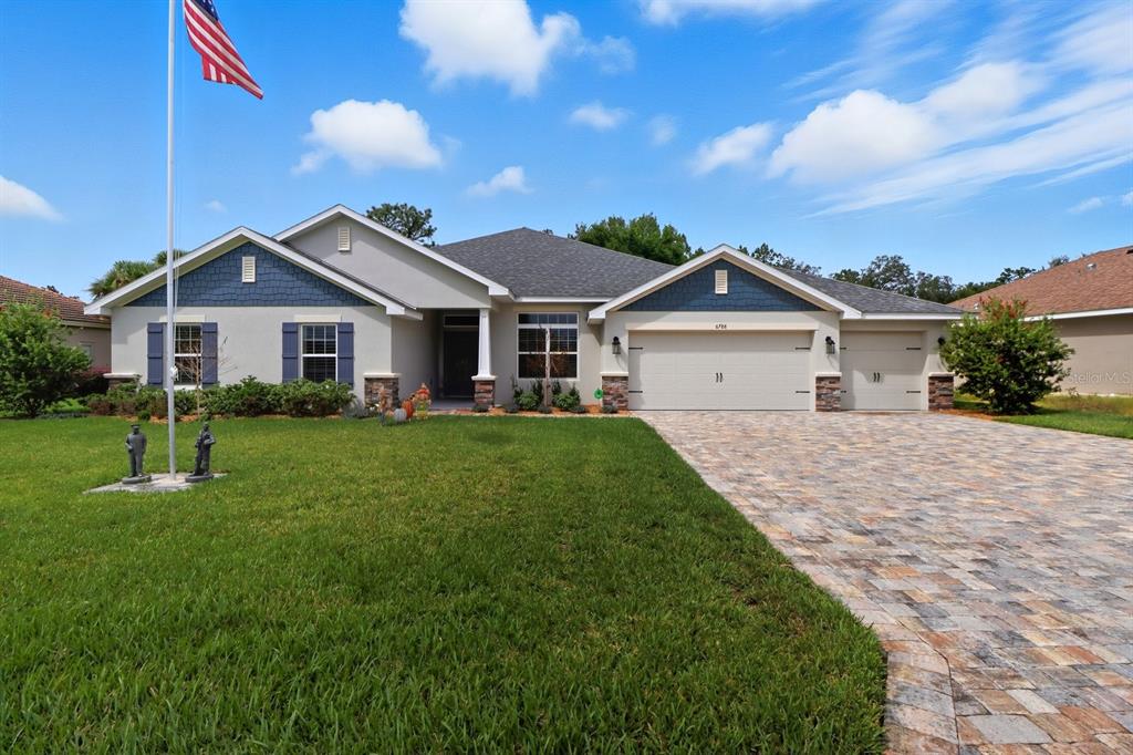a front view of a house with a yard and porch