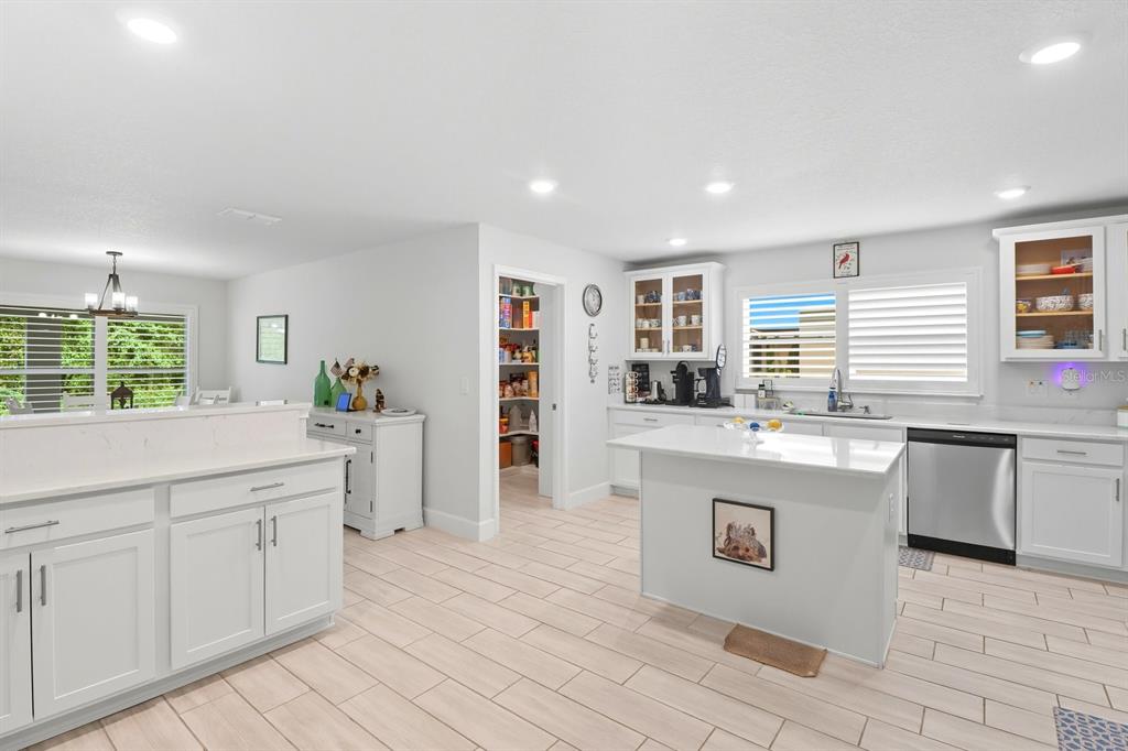 6788 Southwest 179th Ave Road Dunnellon, FL 34432 - Photo 12 of 23 a kitchen with kitchen island granite countertop a stove a sink a dining table and chairs