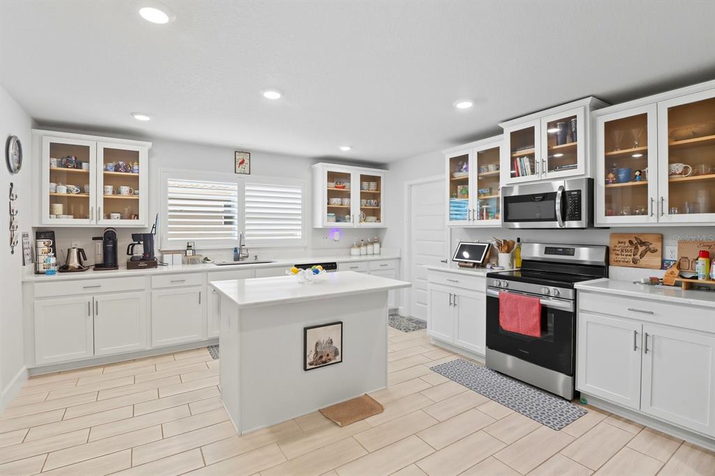 6788 Southwest 179th Ave Road Dunnellon, FL 34432 - Photo 13 of 23 a kitchen with a stove top oven and cabinets