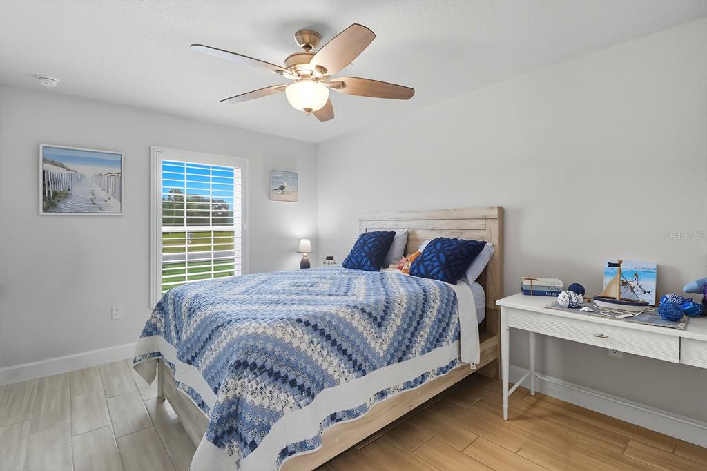 6788 Southwest 179th Ave Road Dunnellon, FL 34432 - Photo 14 of 23 a bedroom with a bed chandelier and a window