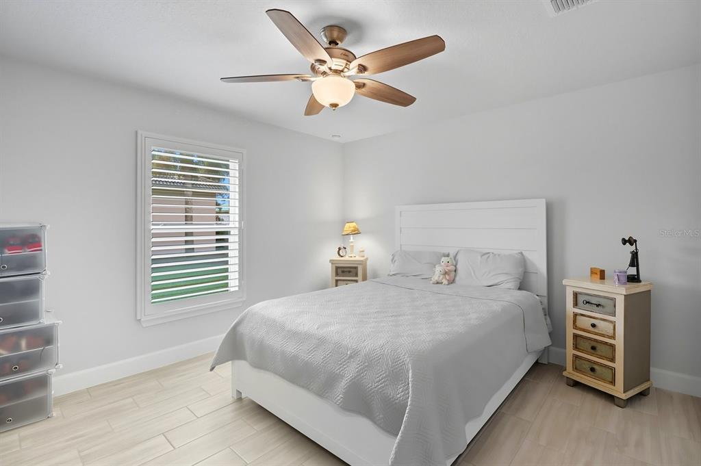 6788 Southwest 179th Ave Road Dunnellon, FL 34432 - Photo 17 of 23 a bedroom with a bed and a chandelier