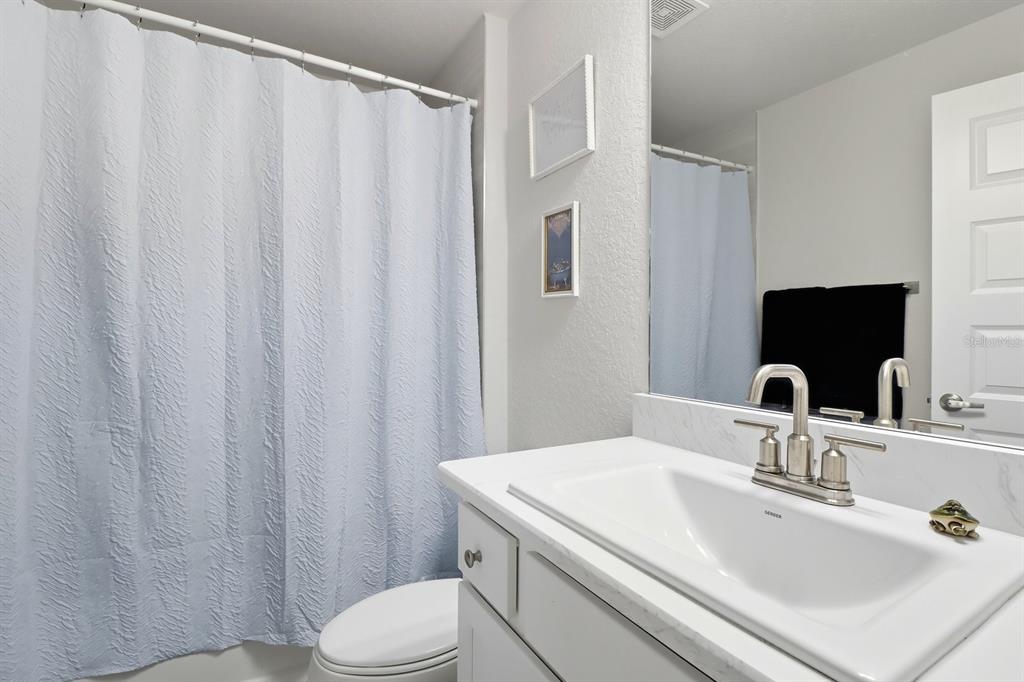 6788 Southwest 179th Ave Road Dunnellon, FL 34432 - Photo 18 of 23 a bathroom with a sink a toilet and shower curtain