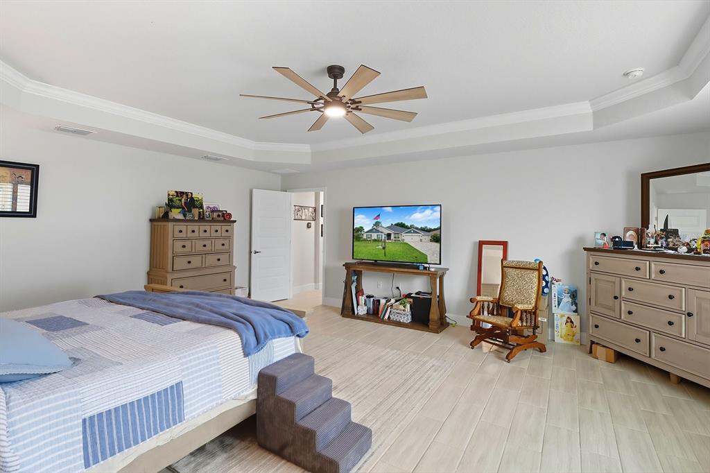 6788 Southwest 179th Ave Road Dunnellon, FL 34432 - Photo 20 of 23 a bedroom with a bed and a chandelier